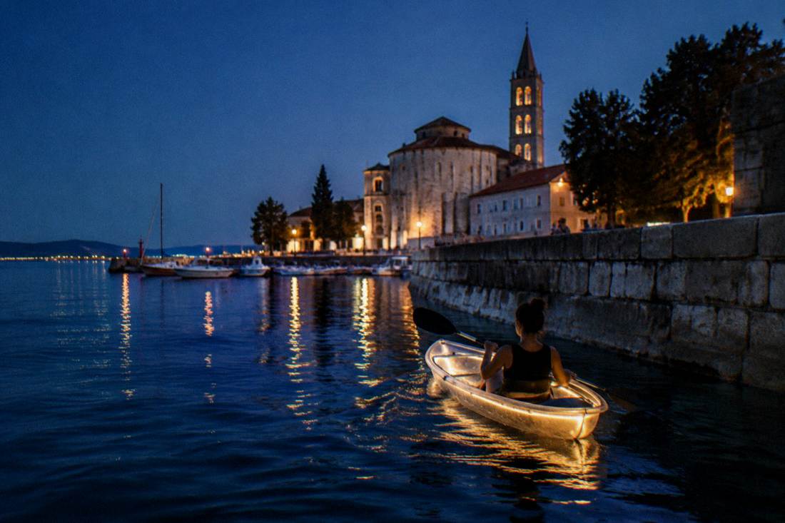 A softly glowing transparent kayak on calm water at night